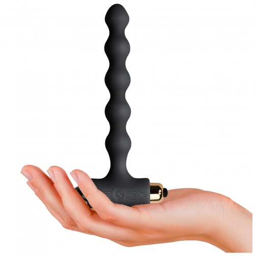 A Pearls Petite Sensations fekete színű, tagolt felületű hosszú análkúp mérete közelről, a kézben tartva.